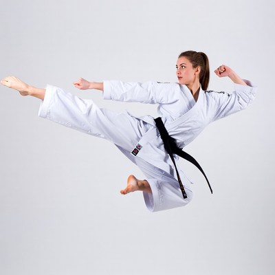 Woman performing karate high kick