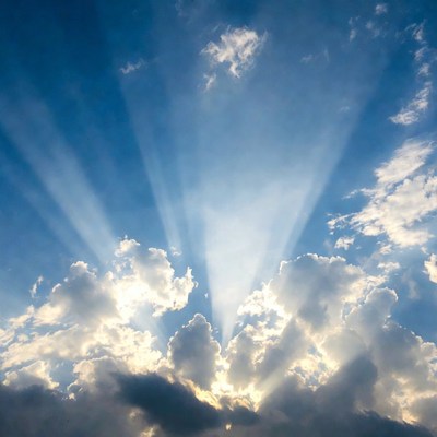 Sun rays beaming through clouds