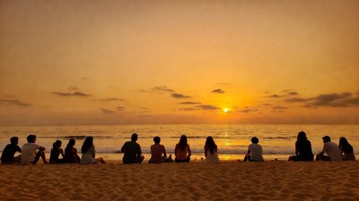Group watching sunset on beach