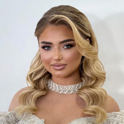 Blonde woman in pearl necklace and gown