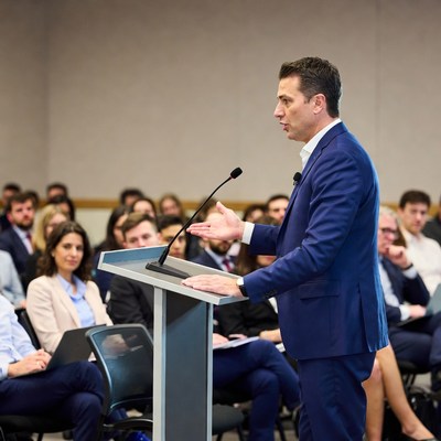 Man speaking at conference podium