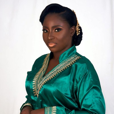 African woman in green embroidered dress