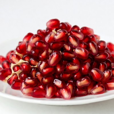 Pomegranate seeds on white plate