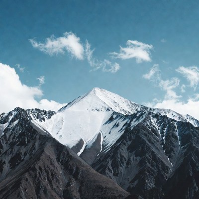 Snowy Mountain Peak with Clouds