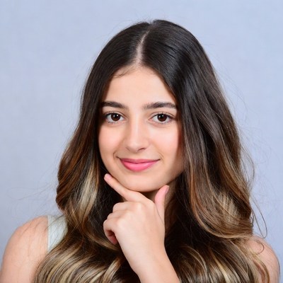 Teen girl hand on chin smiling