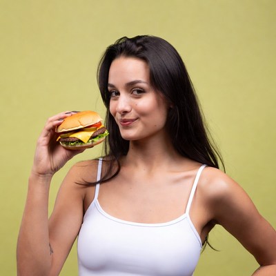 Woman holding cheeseburger