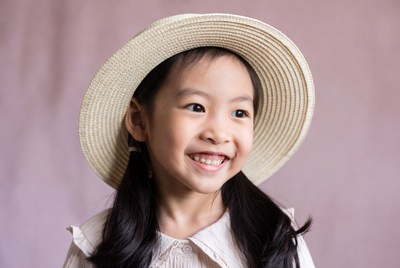 Asian girl smiling in straw hat