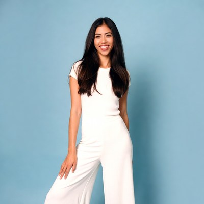Asian woman smiling in white jumpsuit