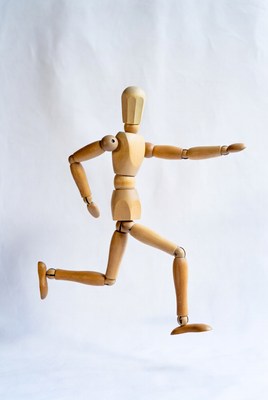 Wooden artist mannequin running pose