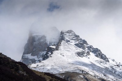 Snowy Mountain Peaks in Clouds