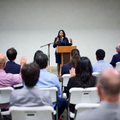 African-American woman speaking at podium