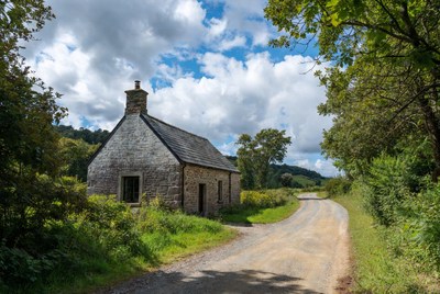 Stone cottage by rural road