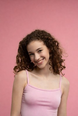 Teen girl smiling with curly hair