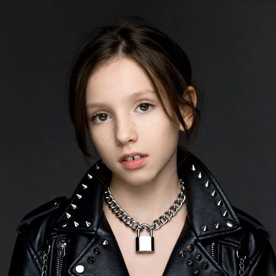 Girl in spiked leather jacket with padlock