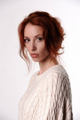 Redhead woman in white sweater
