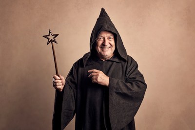 Smiling wizard holding star wand