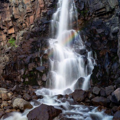 Waterfall with Rainbow in Rocky Canyon
