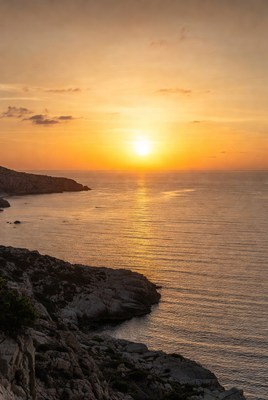 Sunset over rocky coastline
