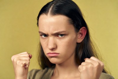 Angry woman clenching fists