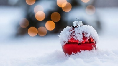 Red Christmas ornament in snow