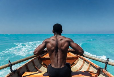 Muscular Black Man Rowing in Ocean