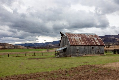 Rustic red barn in green field