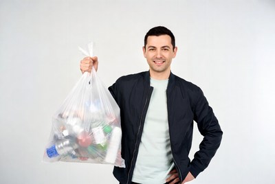 Man holding full plastic trash bag