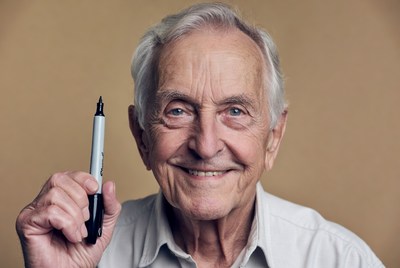 Elderly man holding marker