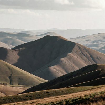 Rolling Hills Landscape Under Cloudy Sky