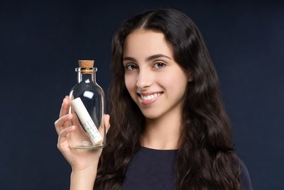Woman holding message in bottle