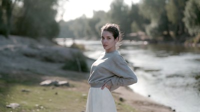Woman standing by riverbank