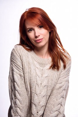 Woman with long red hair in sweater