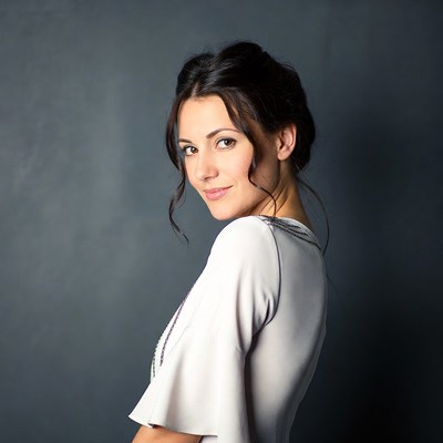 Woman in white dress looking back