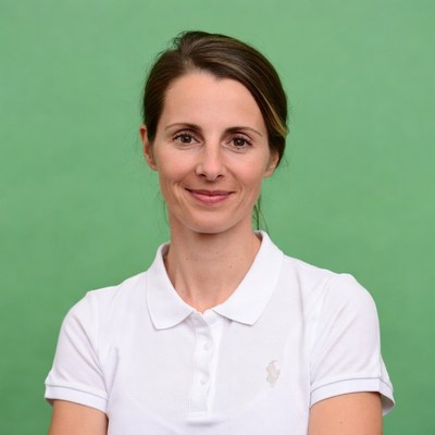 Smiling woman in white polo shirt