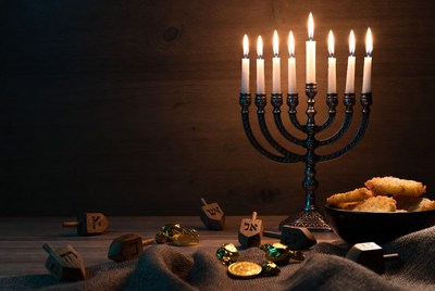 Lit Menorah with Dreidels and Gold Coins