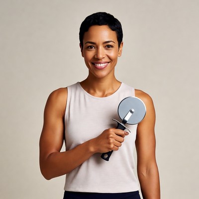 African-American woman holding pizza cutter