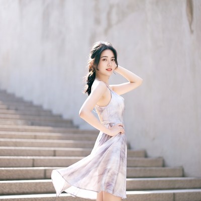 Asian woman in slip dress on stairs