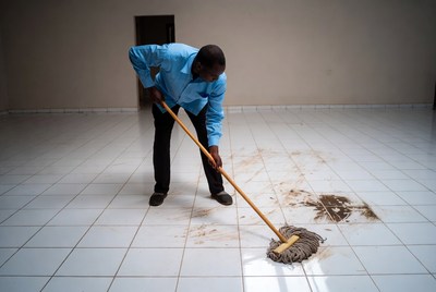 African man mopping floor