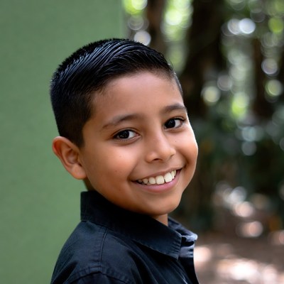 Smiling Latino boy outdoors