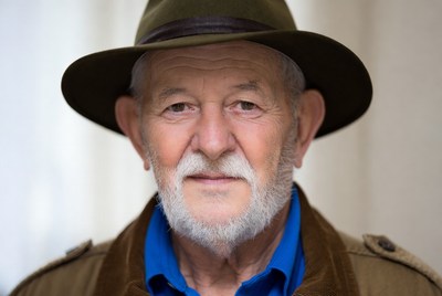 Elderly man wearing green hat