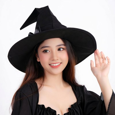 Asian woman waving in witch costume