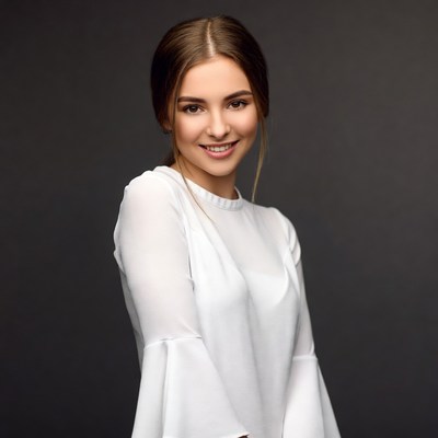 Smiling woman in white bell sleeve dress