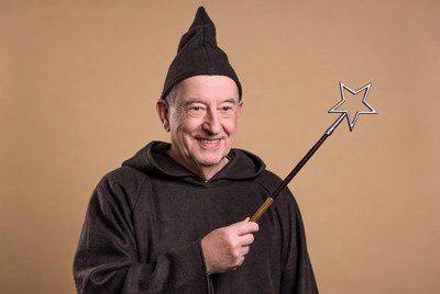 Smiling man in wizard costume with wand