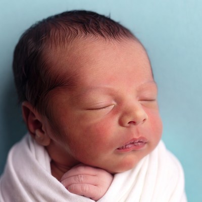 Newborn baby sleeping in white blanket