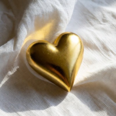 Gold heart on white fabric