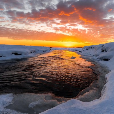 Sunset over snowy river