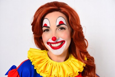 Woman in clown makeup smiling