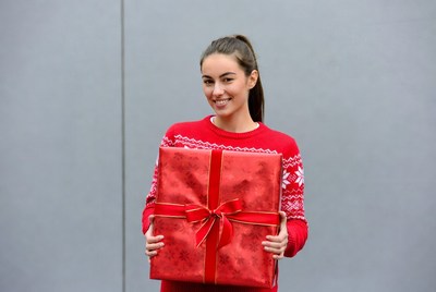 Woman holding red Christmas gift