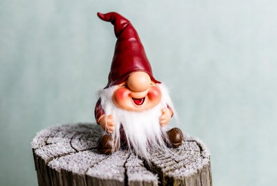 Smiling Gnome on Snowy Stump
