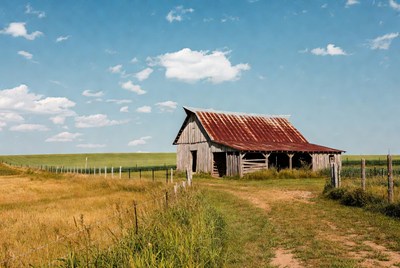 Rustic red barn in golden field